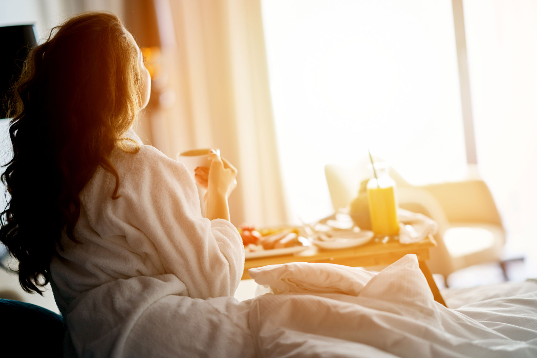 Hotel - Woman enjoying cup of coffee in the morning