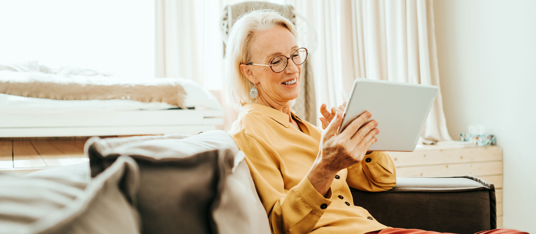 Email Sign Up - Elderly woman on tablet, preparing to sign up for updates.