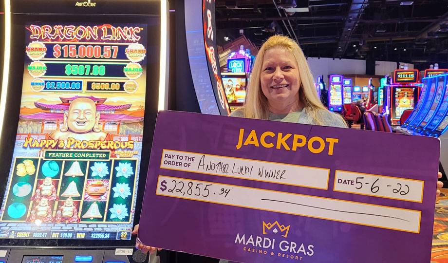 Winners - Jackpot winner with check for $22,855.34