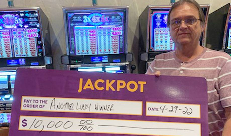 Winners - Jackpot winner with check for $10,000